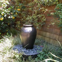 Photo Thumbnail #3: Water feature is an urn where water slowly...