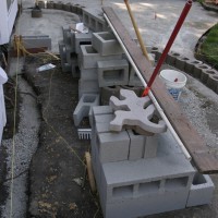 Photo Thumbnail #6: Laying out the wall. The cinder blocks will be...