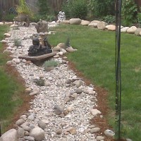 Photo Thumbnail #2: arbor at the front of the dry creek bed.