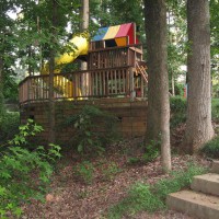 Photo Thumbnail #6: Timber retaining wall tucked into woods creates...