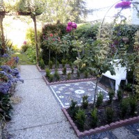 Photo Thumbnail #4: Side rose garden with trellis and pebble mosaic...