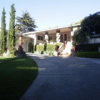 Photo Thumbnail #3: Front yard and driveway. Shown are a...