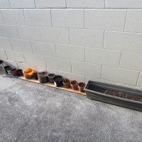 Photo Thumbnail #3: Containers lined up against the porch-wall with...