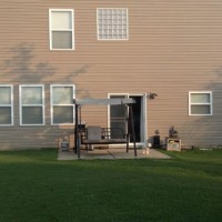 Photo Thumbnail #4: Back of house with small patio, we want to do a...