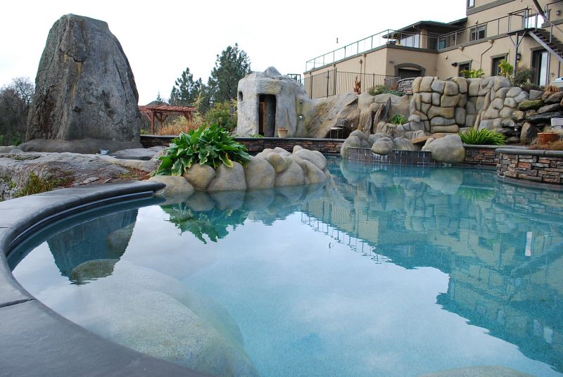 Pool with rocks, water slides, and fountains